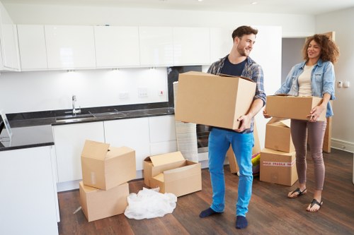 Local moving team handling boxes and household items in Forestgate